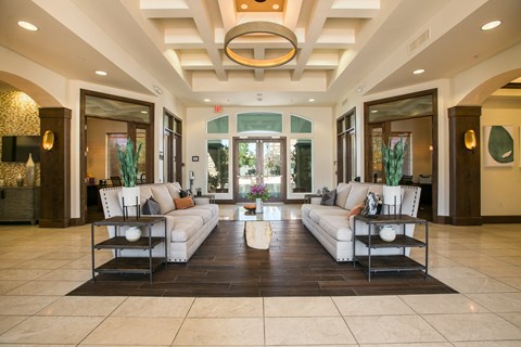 a living room with couches and chairs and a table